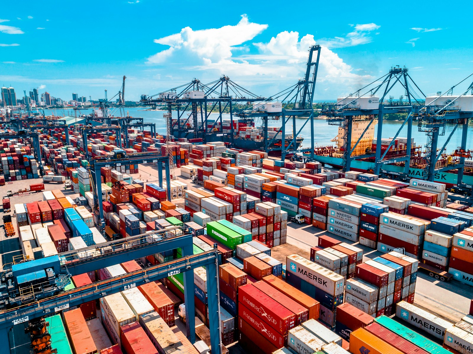 Goldline products ready for shipment in stacked shipping containers