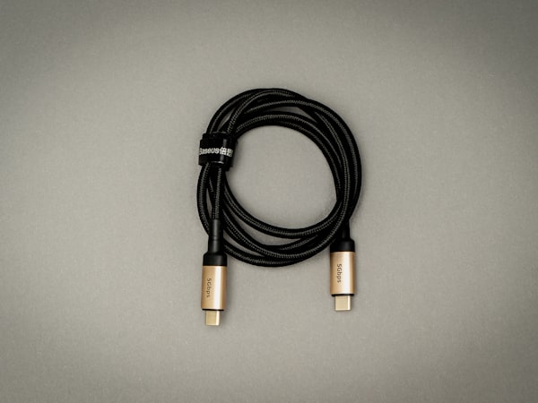 Black electronic cable on a white surface