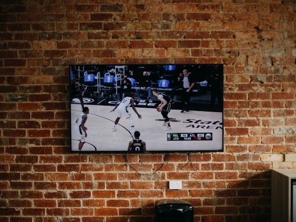 Flat-screen TV mounted on a brick wall