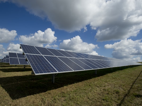 Solar panels installed on a green field